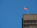 American flag at the top of a tall building